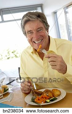 Stock Photo - man eating meal. 
fotosearch - search 
stock photos, 
pictures, images, 
and photo clipart