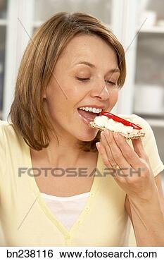 Stock Photo - woman eating snack. 
fotosearch - search 
stock photos, 
pictures, images, 
and photo clipart