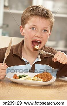 Stock Photograph - boy eating meal. 
fotosearch - search 
stock photos, 
pictures, images, 
and photo clipart