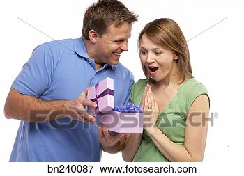 Picture - man showing present 
to woman. fotosearch 
- search stock 
photos, pictures, 
images, and photo 
clipart