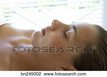 Stock Photo - woman lying down 
with eyes closed. 
fotosearch - search 
stock photos, 
pictures, images, 
and photo clipart