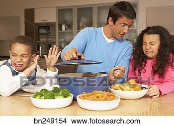 Stock Photo - father having 
meal with unhappy 
children. fotosearch 
- search stock 
photos, pictures, 
images, and photo 
clipart