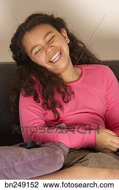 Stock Photo - laughing girl 
watching television. 
fotosearch - search 
stock photos, 
pictures, images, 
and photo clipart