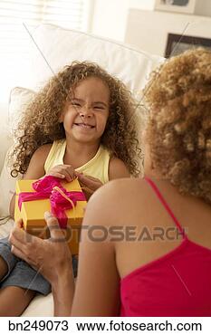 Stock Photo - mother giving 
daughter present. 
fotosearch - search 
stock photos, 
pictures, images, 
and photo clipart