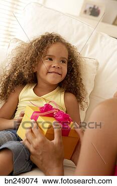 Stock Photo - smiling girl receiving 
present. fotosearch 
- search stock 
photos, pictures, 
images, and photo 
clipart