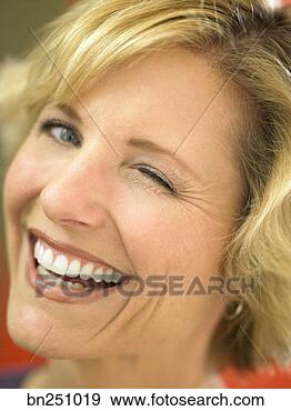 Stock Photograph - smiling woman 
winking. fotosearch 
- search stock 
photos, pictures, 
images, and photo 
clipart