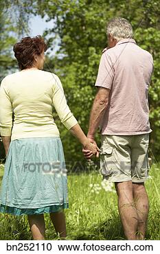 Stock Photography - back view of couple 
holding hands. 
fotosearch - search 
stock photos, 
pictures, images, 
and photo clipart