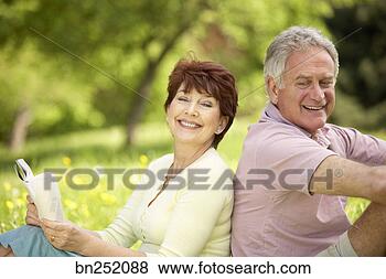 Stock Photo - couple relaxing 
in field. fotosearch 
- search stock 
photos, pictures, 
images, and photo 
clipart