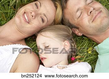 Stock Photo - family resting 
in field. fotosearch 
- search stock 
photos, pictures, 
images, and photo 
clipart
