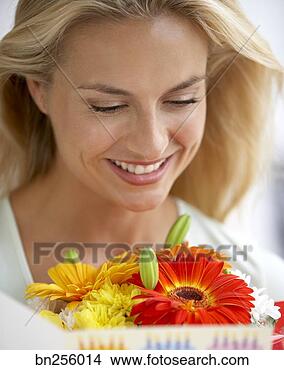 Stock Photo - woman with flowers 
and card. fotosearch 
- search stock 
photos, pictures, 
images, and photo 
clipart