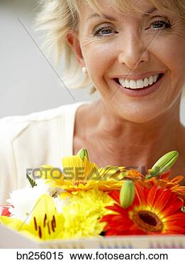 Stock Image - woman with flowers 
and card. fotosearch 
- search stock 
photos, pictures, 
images, and photo 
clipart