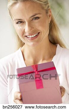 Picture - woman holding 
gift. fotosearch 
- search stock 
photos, pictures, 
images, and photo 
clipart