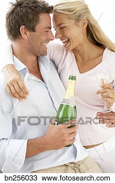 Stock Photo - woman and man 
with champagne 
bottle and glasses. 
fotosearch - search 
stock photos, 
pictures, images, 
and photo clipart