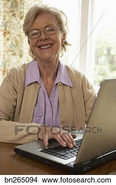 Stock Photo - smiling woman 
with laptop. fotosearch 
- search stock 
photos, pictures, 
images, and photo 
clipart