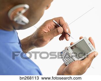 Stock Photo - businessman with 
headset and pda. 
fotosearch - search 
stock photos, 
pictures, images, 
and photo clipart