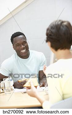 Stock Photo - man eating lunch 
with co-worker. 
fotosearch - search 
stock photos, 
pictures, images, 
and photo clipart