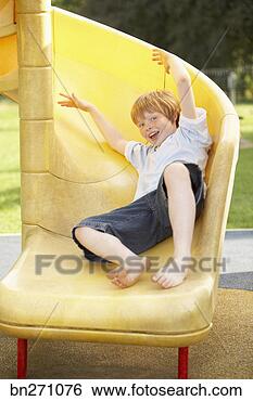 Stock Photo - boy on a slide. 
fotosearch - search 
stock photos, 
pictures, images, 
and photo clipart