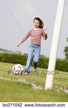 Stock Photo - girl kicking a 
soccer ball. fotosearch 
- search stock 
photos, pictures, 
images, and photo 
clipart