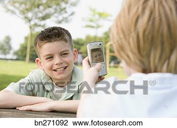 Stock Photo - kid taking a picture 
of another kid. 
fotosearch - search 
stock photos, 
pictures, images, 
and photo clipart