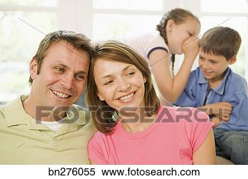 Stock Image - children whispering 
behind parents. 
fotosearch - search 
stock photos, 
pictures, images, 
and photo clipart
