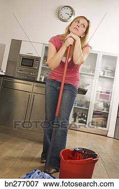 Picture - woman daydreaming 
while mopping. 
fotosearch - search 
stock photos, 
pictures, images, 
and photo clipart