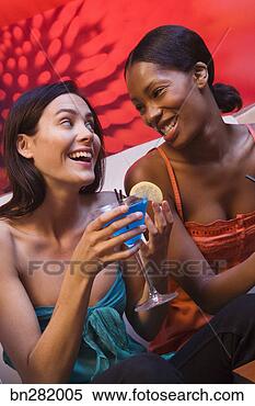 Stock Image - women laughing 
and having drinks. 
fotosearch - search 
stock photos, 
pictures, images, 
and photo clipart