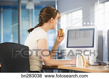 Stock Photo - office worker 
eating at desk. 
fotosearch - search 
stock photos, 
pictures, images, 
and photo clipart