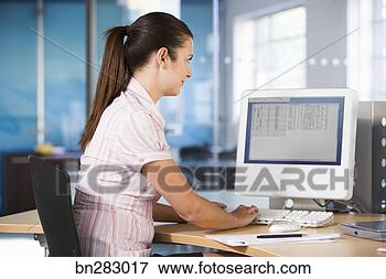 Picture - office worker 
using computer. 
fotosearch - search 
stock photos, 
pictures, images, 
and photo clipart