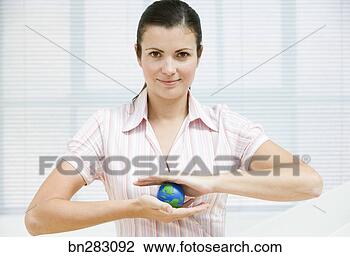 Stock Photo - woman holding 
small globe. fotosearch 
- search stock 
photos, pictures, 
images, and photo 
clipart
