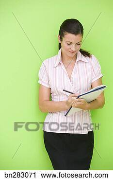 Stock Photography - woman taking notes 
in notebook. fotosearch 
- search stock 
photos, pictures, 
images, and photo 
clipart