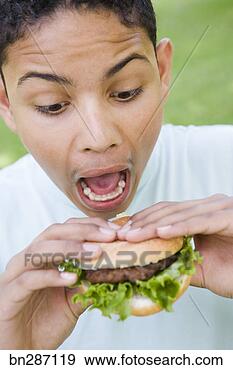 Stock Photograph - boy eating hamburger. 
fotosearch - search 
stock photos, 
pictures, images, 
and photo clipart