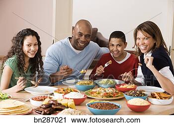 Stock Photography - family eating 
dinner together. 
fotosearch - search 
stock photos, 
pictures, images, 
and photo clipart