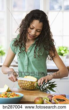 Stock Photo - girl cutting fruit. 
fotosearch - search 
stock photos, 
pictures, images, 
and photo clipart