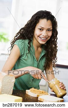 Stock Photograph - girl smearing 
peanut butter 
on bread. fotosearch 
- search stock 
photos, pictures, 
images, and photo 
clipart