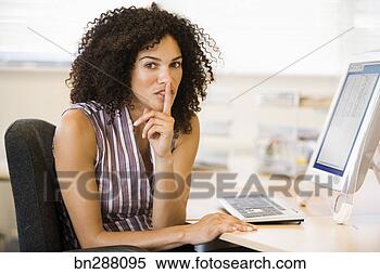 Stock Image - businesswoman 
making quiet gesture 
at desk. fotosearch 
- search stock 
photos, pictures, 
images, and photo 
clipart