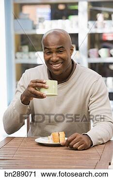 Stock Photography - man drinking coffee 
with cake. fotosearch 
- search stock 
photos, pictures, 
images, and photo 
clipart