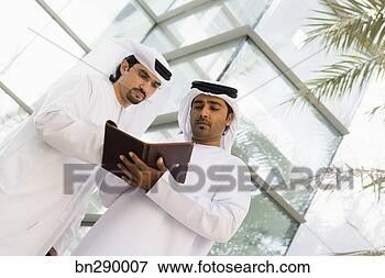 Picture - businessmen reviewing 
day planner. fotosearch 
- search stock 
photos, pictures, 
images, and photo 
clipart