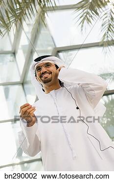 Stock Photo - smiling man listening 
to music. fotosearch 
- search stock 
photos, pictures, 
images, and photo 
clipart