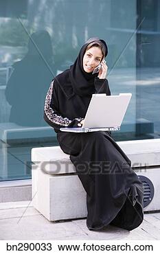 Stock Photo - woman with laptop 
and cell phone. 
fotosearch - search 
stock photos, 
pictures, images, 
and photo clipart