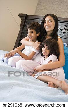 Stock Photo - mother hugging 
children in bed. 
fotosearch - search 
stock photos, 
pictures, images, 
and photo clipart