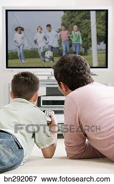 Picture - boy and father 
watching television. 
fotosearch - search 
stock photos, 
pictures, images, 
and photo clipart