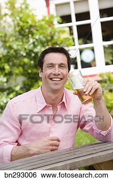 Stock Photo - man with beer 
outdoors. fotosearch 
- search stock 
photos, pictures, 
images, and photo 
clipart