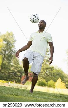 Stock Photograph - man bouncing ball 
on knee. fotosearch 
- search stock 
photos, pictures, 
images, and photo 
clipart