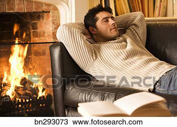 Stock Photo - man napping on 
sofa next to fireplace. 
fotosearch - search 
stock photos, 
pictures, images, 
and photo clipart