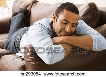 Stock Photo - man napping on 
sofa. fotosearch 
- search stock 
photos, pictures, 
images, and photo 
clipart