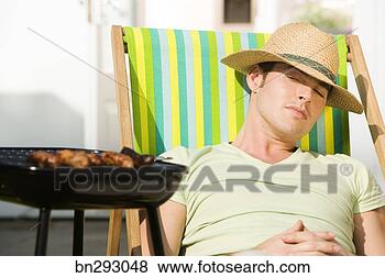 Stock Photo - man sleeping next 
to grill. fotosearch 
- search stock 
photos, pictures, 
images, and photo 
clipart