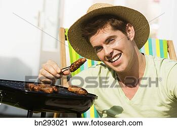 Stock Photography - smiling man holding 
sausage. fotosearch 
- search stock 
photos, pictures, 
images, and photo 
clipart