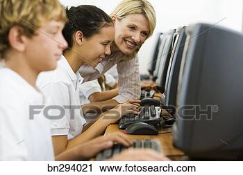 Stock Photography - teacher helping 
student on computer. 
fotosearch - search 
stock photos, 
pictures, images, 
and photo clipart
