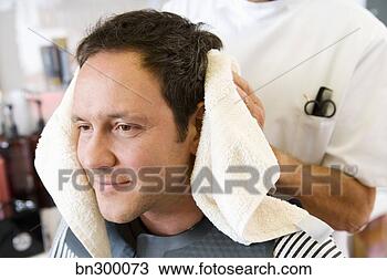 Stock Photo - barber caring 
for man's hair. 
fotosearch - search 
stock photos, 
pictures, images, 
and photo clipart