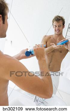 Stock Photograph - men using hair 
gel. fotosearch 
- search stock 
photos, pictures, 
images, and photo 
clipart